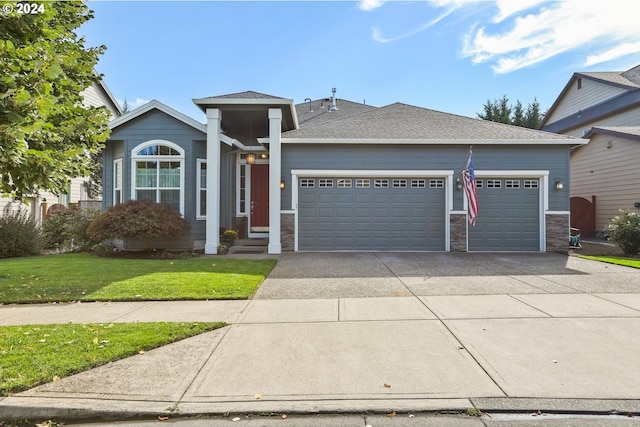 view of front of home featuring a garage and a front yard