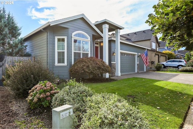 view of front of house featuring a garage and a front lawn