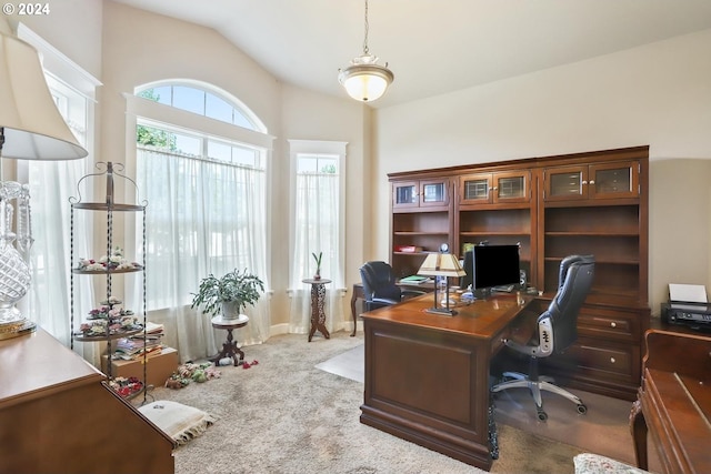 office space featuring vaulted ceiling and light colored carpet