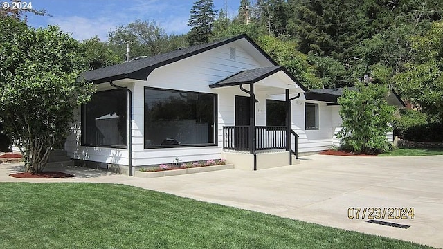 view of front of house with a front yard and a porch