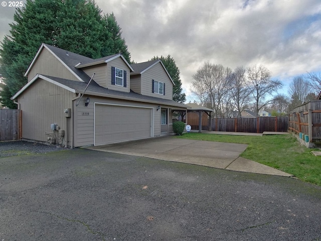 view of front of home featuring a garage and a front lawn