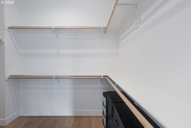 walk in closet featuring hardwood / wood-style flooring