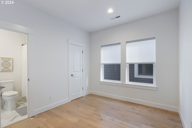 unfurnished room with light hardwood / wood-style flooring