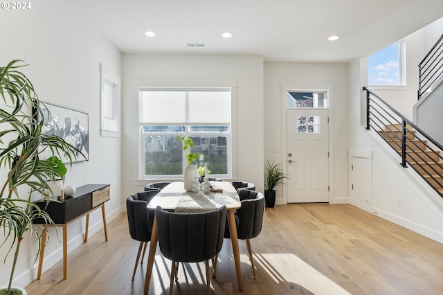 dining area with light hardwood / wood-style flooring and plenty of natural light