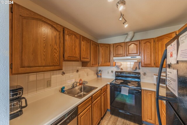 kitchen featuring tasteful backsplash, black range with electric cooktop, sink, stainless steel dishwasher, and light hardwood / wood-style flooring