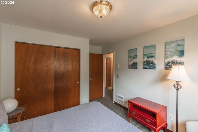 bedroom featuring a closet and dark carpet