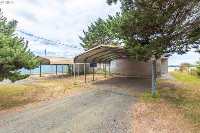 view of parking / parking lot featuring a carport