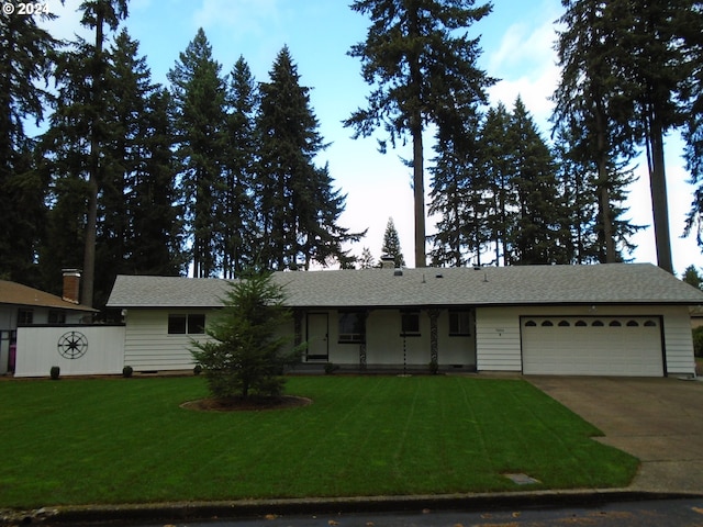 ranch-style home with a garage and a front yard