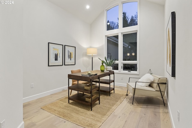 sitting room with vaulted ceiling and light hardwood / wood-style floors