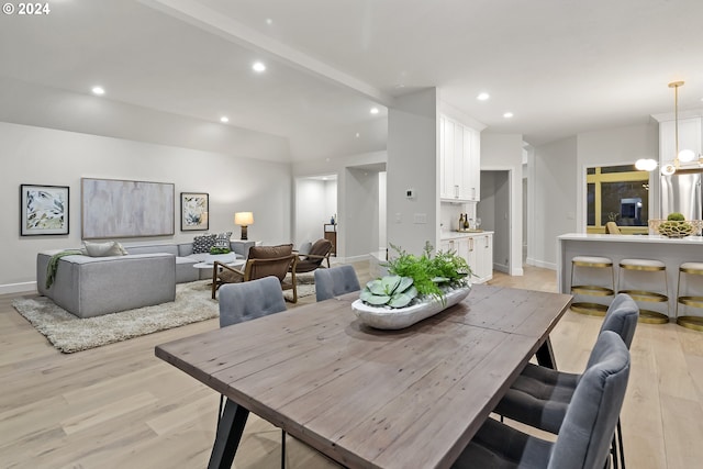 dining area featuring an inviting chandelier and light wood-type flooring