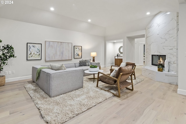 living room featuring a fireplace and light wood-type flooring