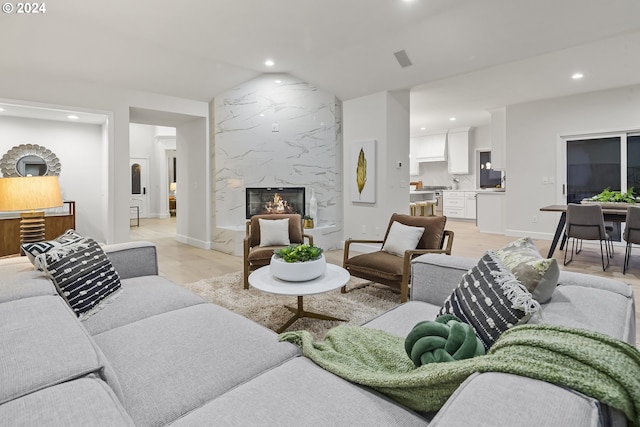 living room featuring light hardwood / wood-style flooring and a premium fireplace