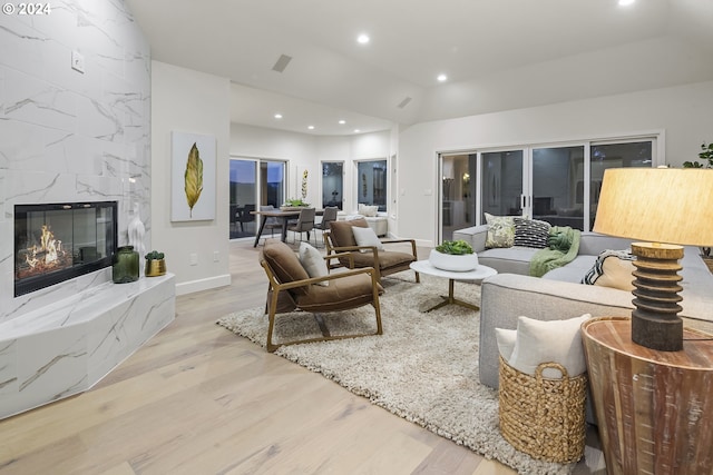 living room featuring a premium fireplace and light hardwood / wood-style floors