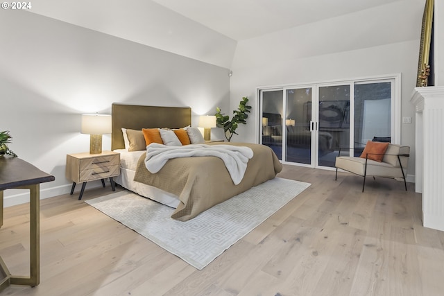 bedroom with access to outside and light hardwood / wood-style floors