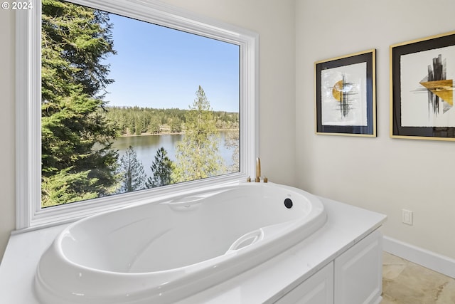 bathroom with plenty of natural light, tile floors, and a bath to relax in