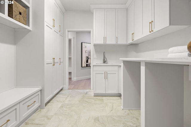 washroom featuring light tile flooring and sink