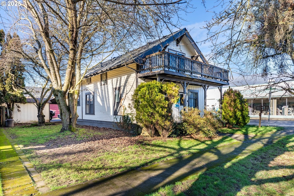 view of home's exterior featuring a deck and a lawn