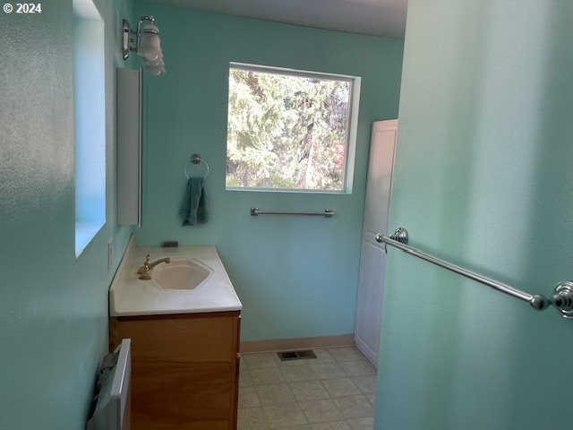 725 Snowden Rd, White Salmon, WA 98672 - bathroom with radiator heating unit and vanity