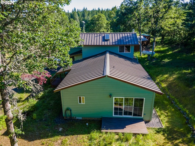 725 Snowden Rd, White Salmon, WA 98672 - back of house featuring metal roof, a view of trees, a lawn, and a standing seam roof