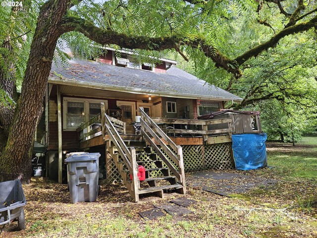 back of property featuring a wooden deck