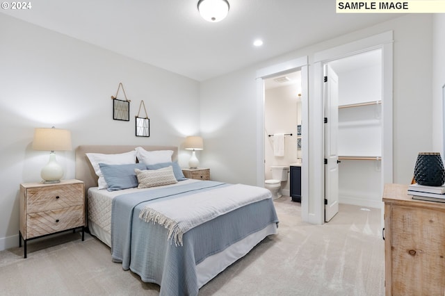 carpeted bedroom with ensuite bath, a walk in closet, and a closet