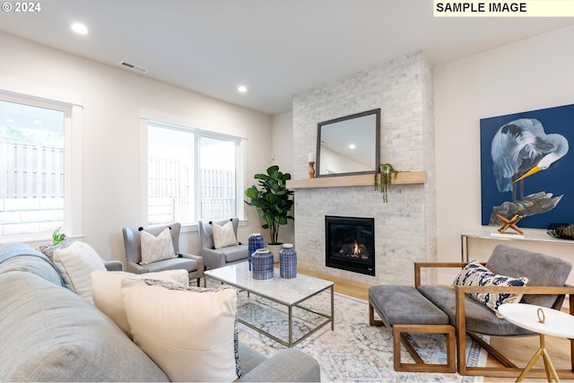 living room with hardwood / wood-style flooring and a fireplace