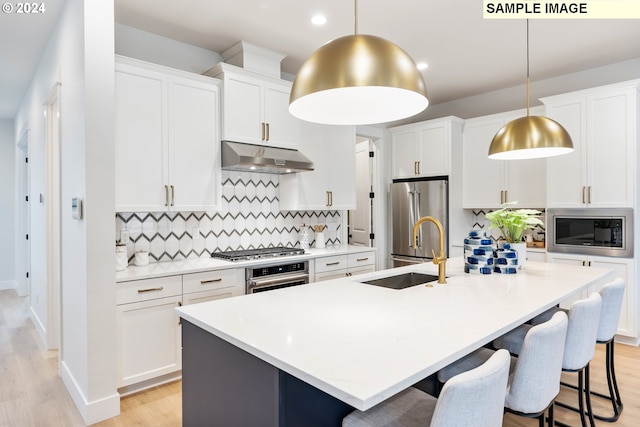 kitchen with a kitchen island with sink, backsplash, stainless steel appliances, and exhaust hood