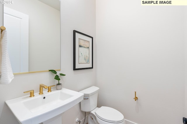 bathroom featuring sink and toilet