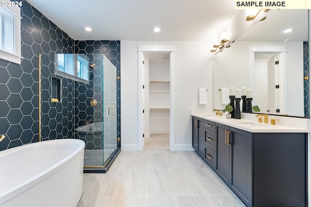 bathroom with vanity and independent shower and bath