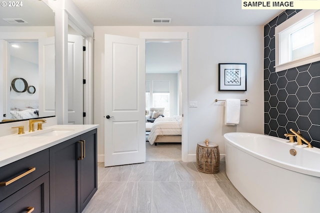 bathroom featuring a tub to relax in and vanity