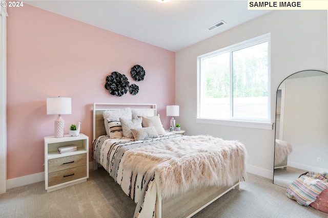 bedroom with light colored carpet