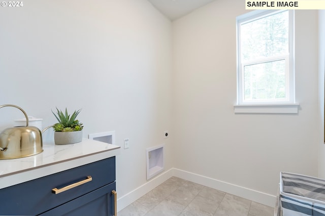 laundry room with cabinets, a wealth of natural light, washer hookup, and hookup for an electric dryer