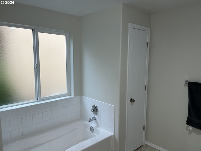 bathroom with a tub to relax in