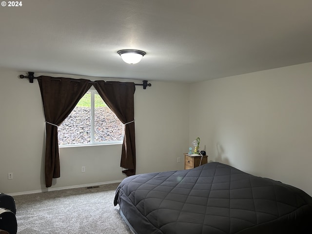 carpeted bedroom featuring a textured ceiling