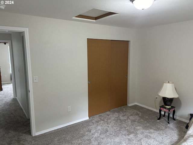 unfurnished bedroom featuring carpet and a closet