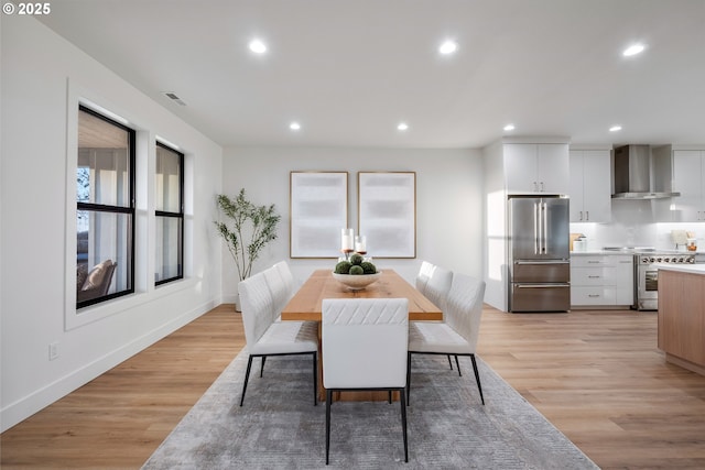 dining room featuring light wood finished floors, visible vents, recessed lighting, and baseboards