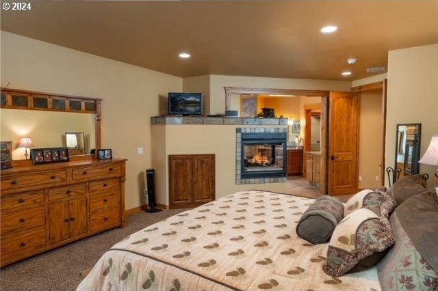 bedroom featuring carpet floors and a multi sided fireplace