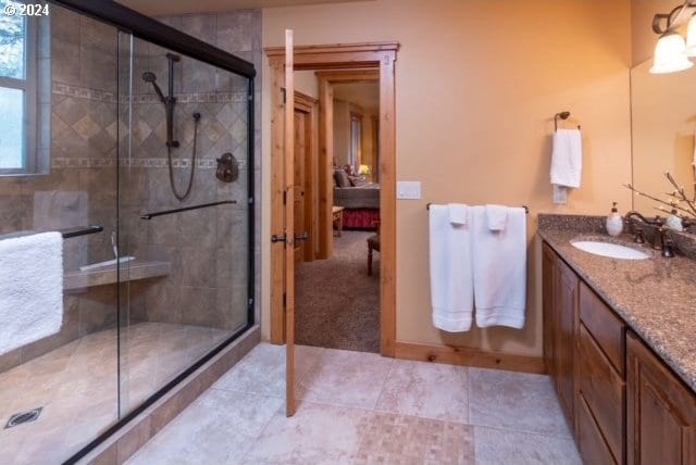 bathroom featuring vanity and a shower with shower door