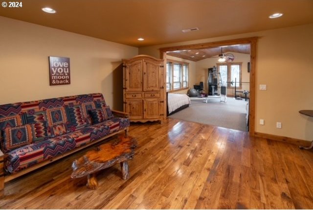 living room featuring light wood-type flooring, ceiling fan, and french doors