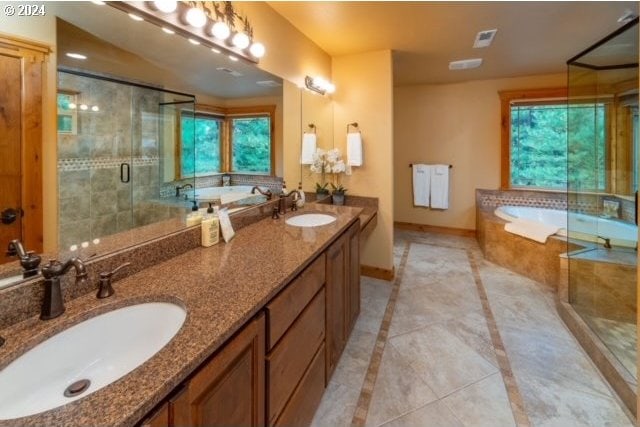 bathroom featuring independent shower and bath, tile patterned flooring, vanity, and plenty of natural light