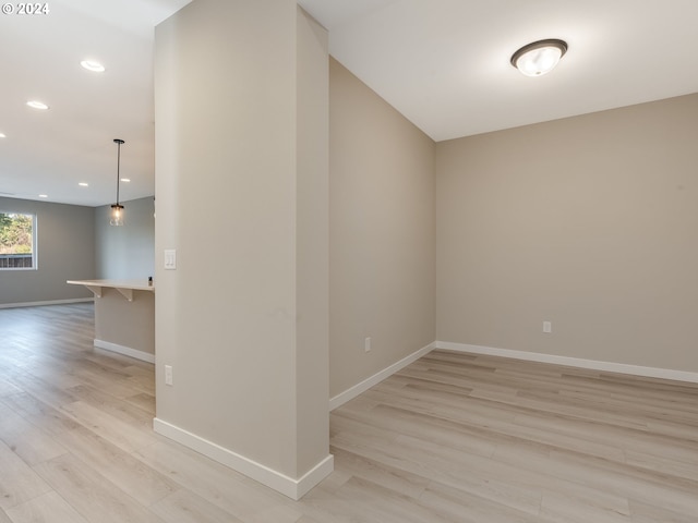 unfurnished room with recessed lighting, light wood-style floors, and baseboards