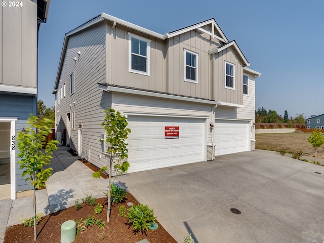 view of front facade with a garage, board and batten siding, and concrete driveway