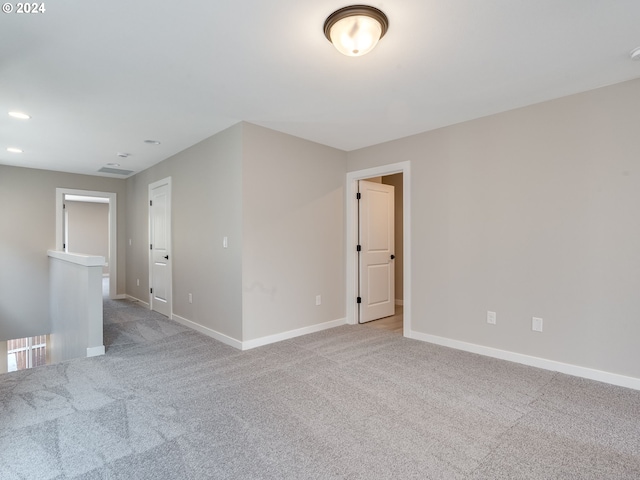 carpeted spare room featuring recessed lighting and baseboards