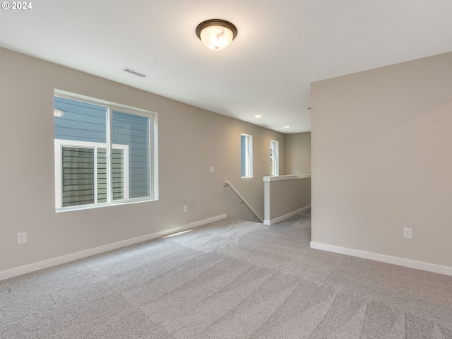 carpeted spare room with visible vents, recessed lighting, and baseboards