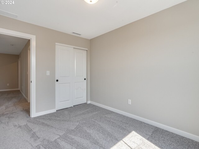 unfurnished room with light carpet