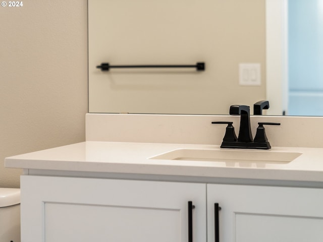 half bathroom featuring toilet and vanity