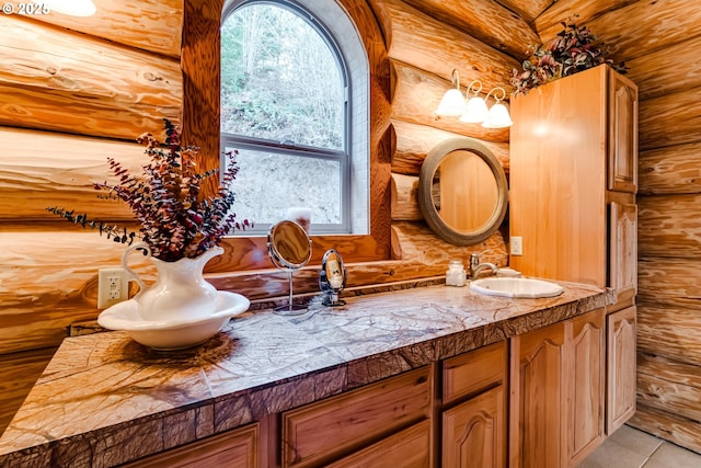 bathroom with vanity and rustic walls