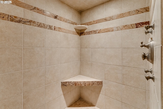 bathroom with a tile shower