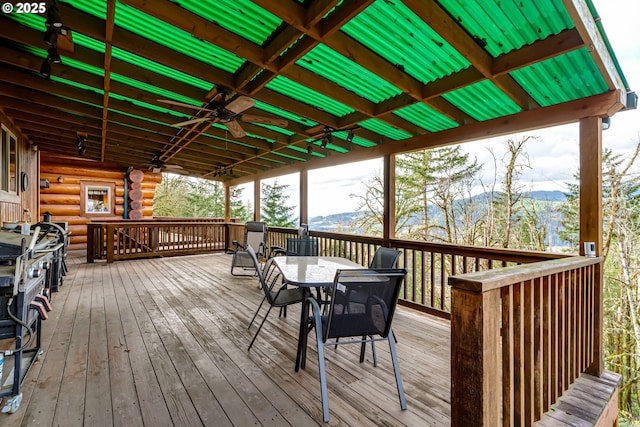 wooden deck with ceiling fan and a mountain view