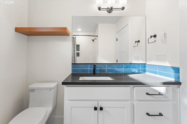 bathroom featuring walk in shower, vanity, and toilet